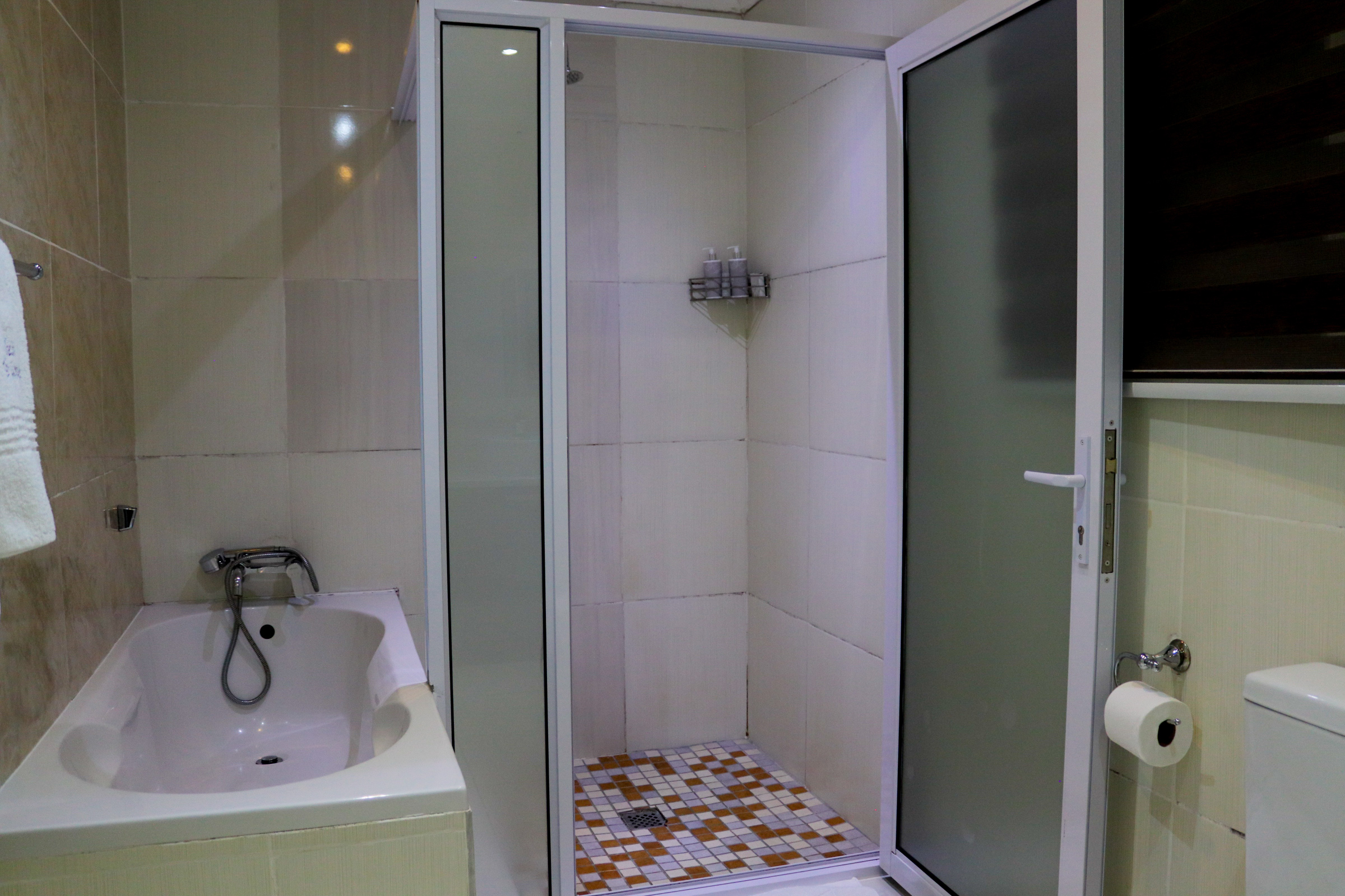 Lillies Guest Lodge bathroom with bath and shower